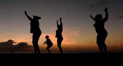 Women Jumping together in the twilight